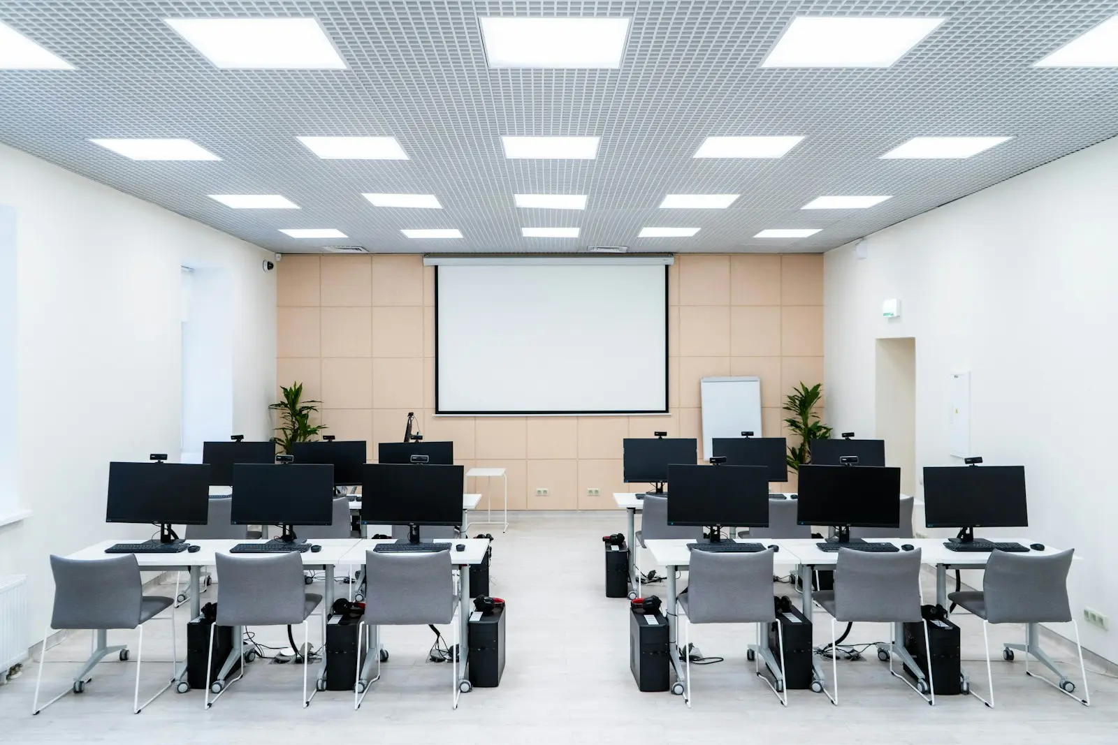 a room of desks with computers