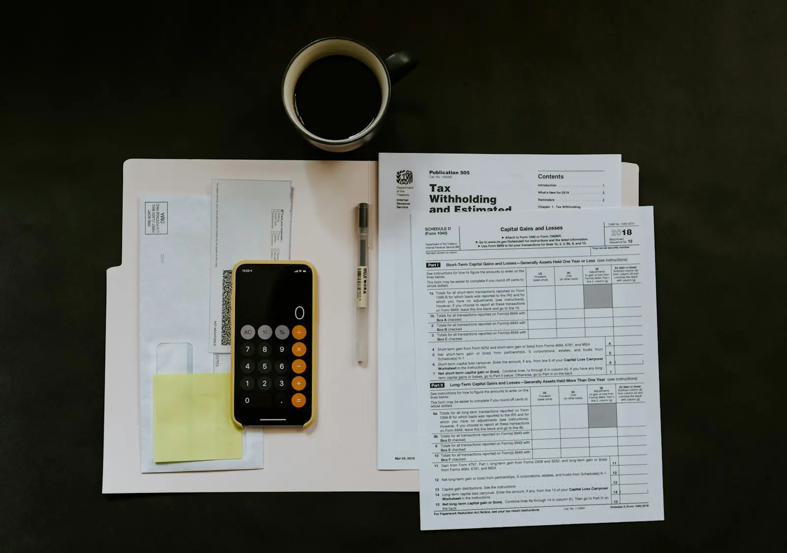 a tax form, a calculator and a notebook on a desk